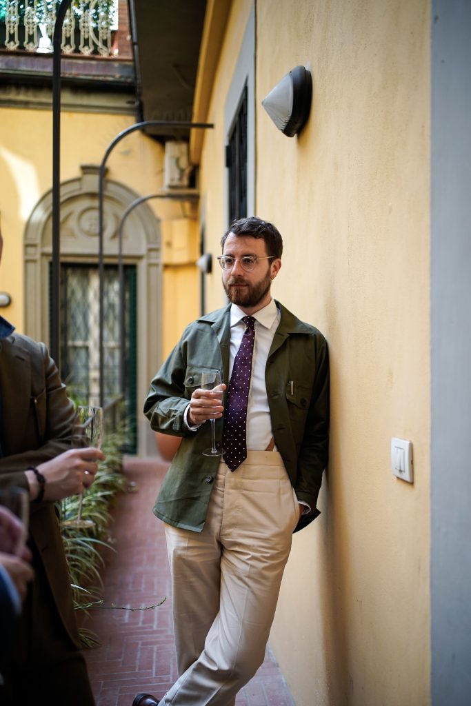 Wiliam with a version of olive field jacket with beige bespoke trousers